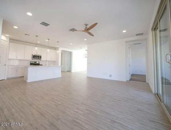 an empty room with closet and windows