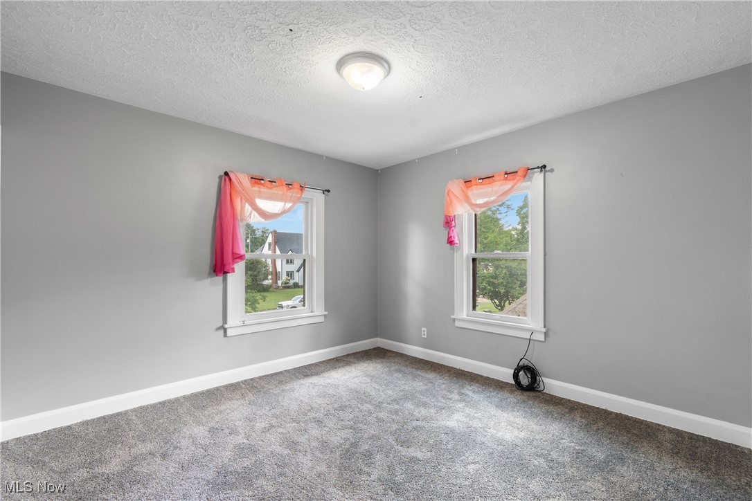 302 Poplar Avenue Northwest Canton, OH 44708 - Photo 22 of 34 Spare room featuring carpet and a textured ceiling