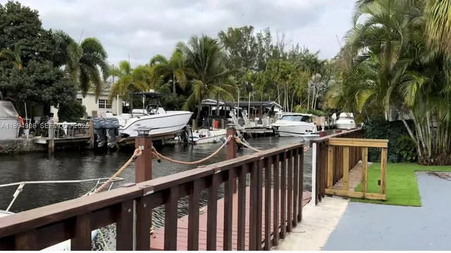 a view of a balcony with wooden floor and outdoor seating