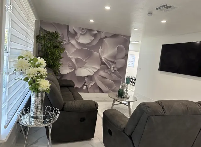 a living room with furniture and a flat screen tv