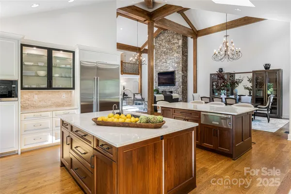 a kitchen with stainless steel appliances granite countertop a sink and a stove