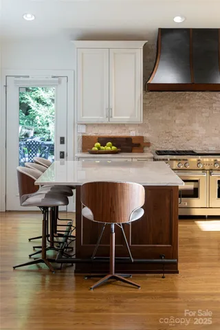 a kitchen with wooden cabinets a stove and a microwave