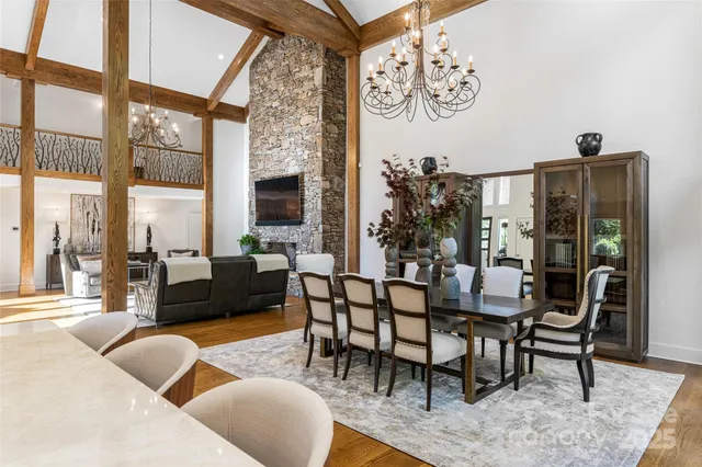 a dining room with furniture and a large window