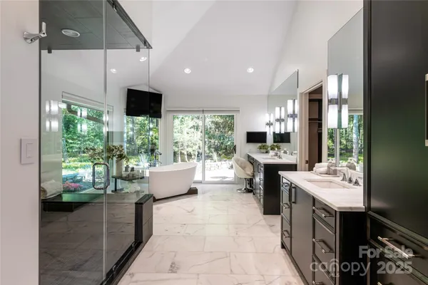 a living room with a large window and furniture