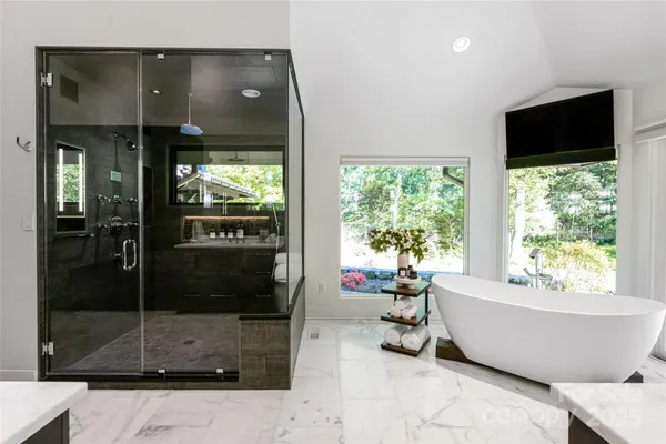 a white tub sitting in front of a window