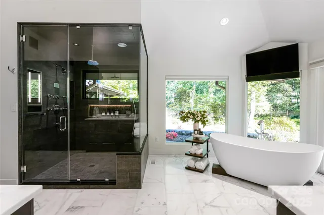 a white tub sitting in front of a window