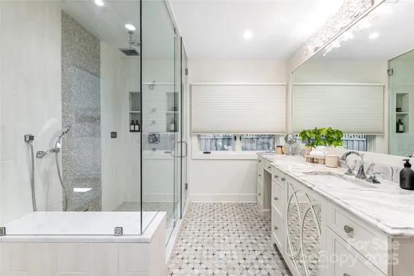 a kitchen with stainless steel appliances a stove a microwave a sink and cabinets