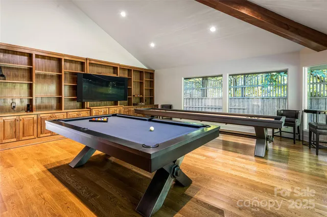 a view of swimming pool with outdoor seating and trees