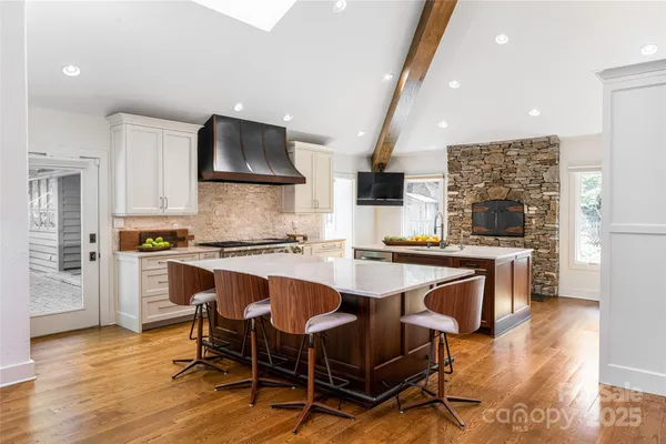 a kitchen with stainless steel appliances a sink and a refrigerator