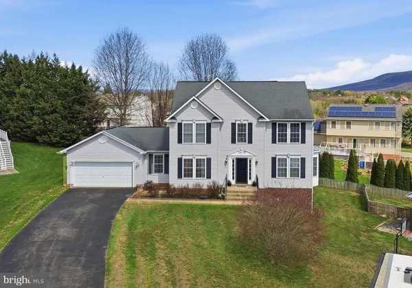 a view of a house with backyard and porch