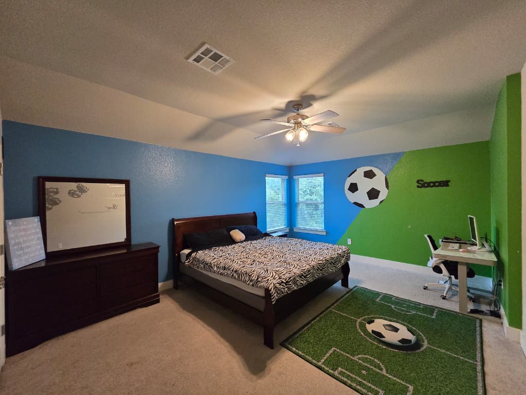 9713 McKnight Loop, Unit 34 Austin, TX 78717 - Photo 12 of 17 a bedroom with a bed and a chandelier