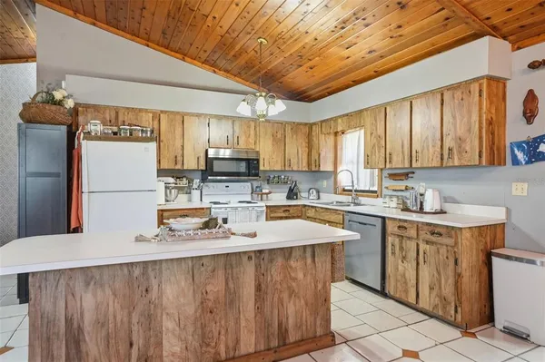 a kitchen with refrigerator a sink and cabinets