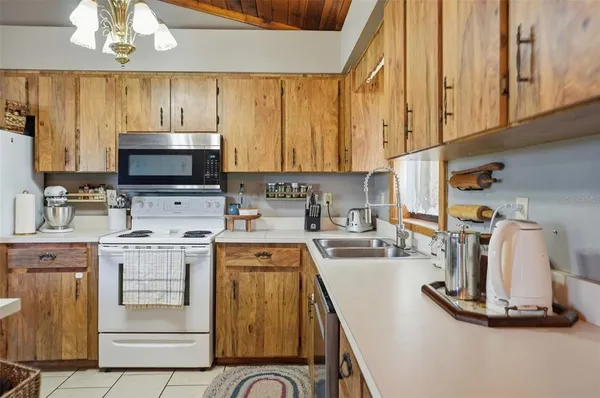 a kitchen with a stove a sink and a microwave