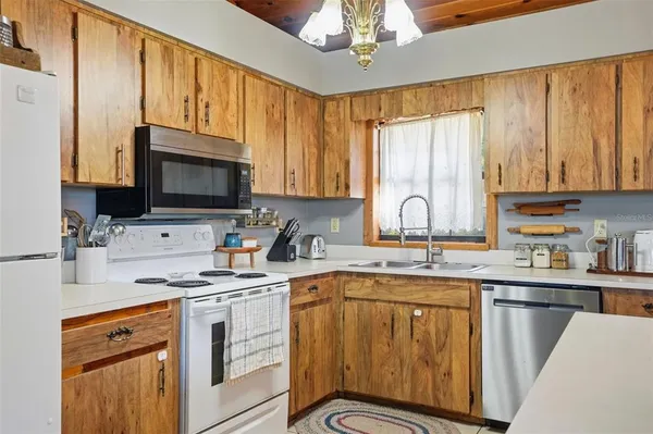 a kitchen with stainless steel appliances a stove sink microwave and cabinets