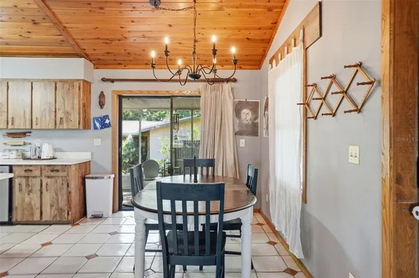 a dining room with furniture a chandelier and window