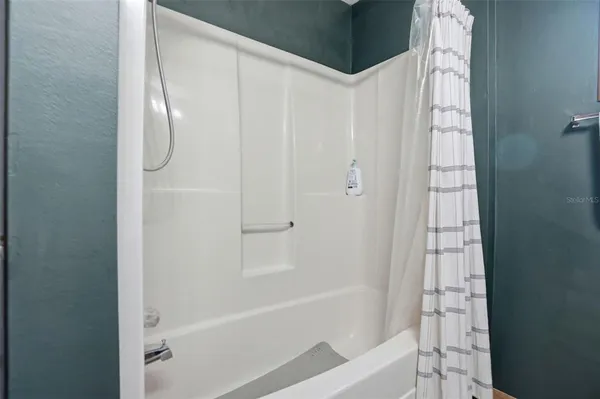 a bathroom with a bathtub and a shower