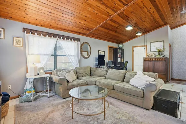 a living room with furniture a fireplace and a large window