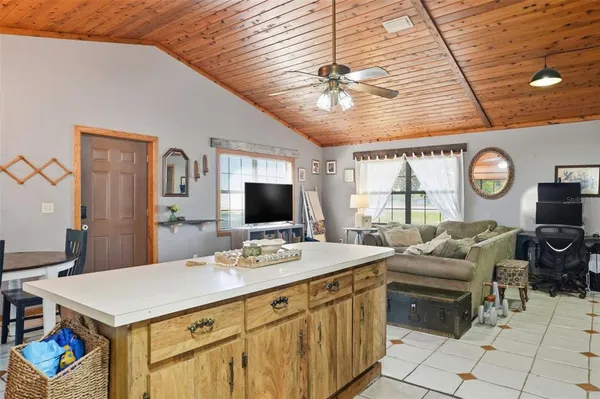 a view of a livingroom with furniture and a ceiling fan