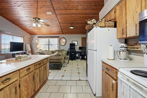 a kitchen with a sink stainless steel appliances a refrigerator and a stove