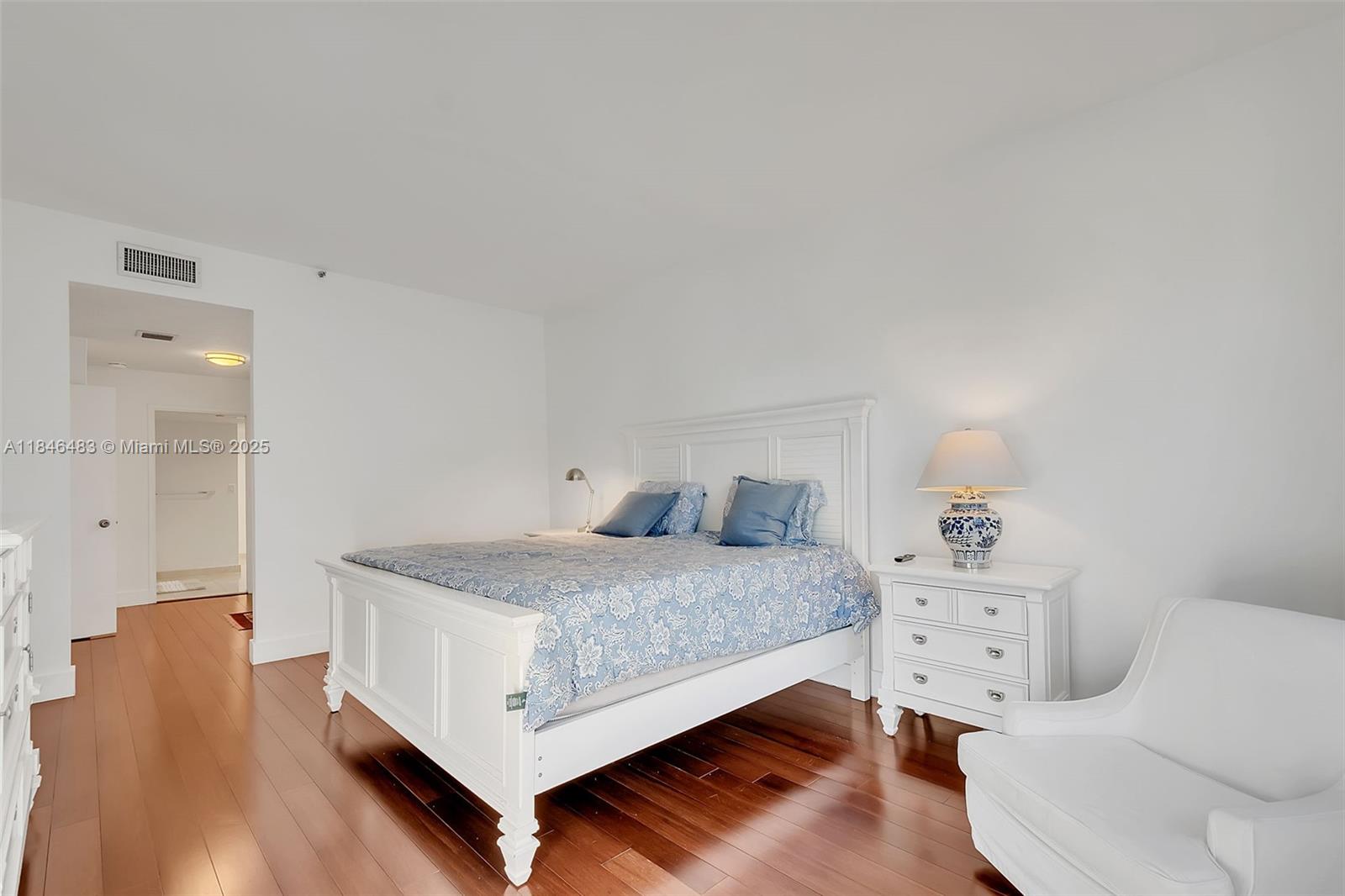 151 Crandon Boulevard, Unit 237 Key Biscayne, FL 33149 - Photo 19 of 28 a bedroom with a bed and lamp