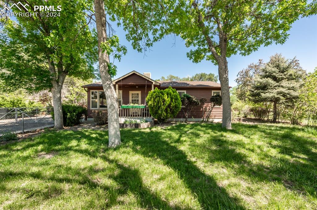 a front view of a house with garden