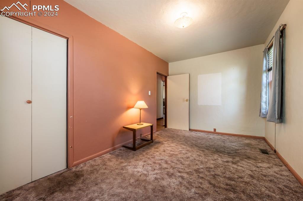 2233 Daniel Road Pueblo, CO 81006 - Photo 15 of 48 a view of a room with a bench and mirror