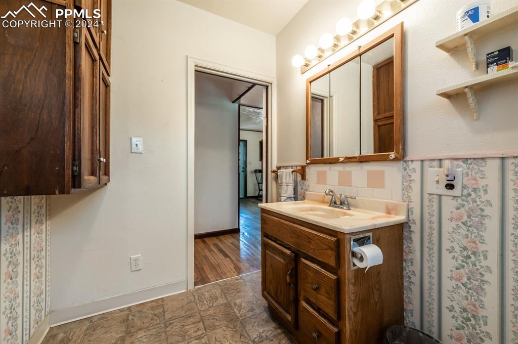 2233 Daniel Road Pueblo, CO 81006 - Photo 18 of 48 a bathroom with a sink a mirror and a shower