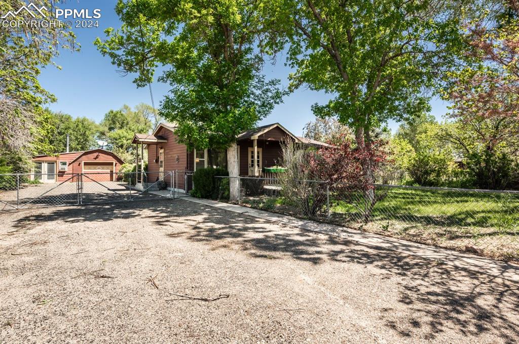 2233 Daniel Road Pueblo, CO 81006 - Photo 2 of 48 a view of a house with a yard