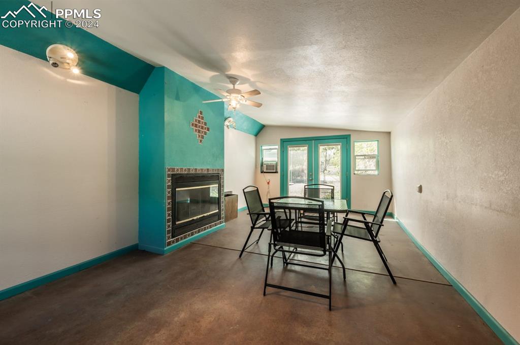 2233 Daniel Road Pueblo, CO 81006 - Photo 28 of 48 a dining room with furniture and a fireplace