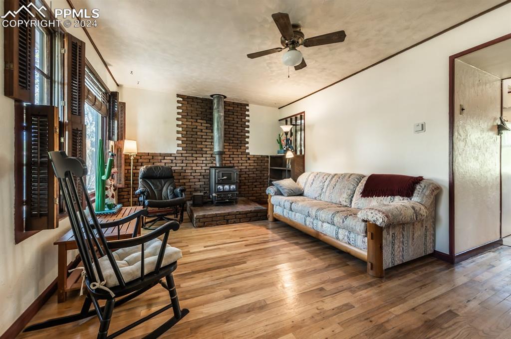 2233 Daniel Road Pueblo, CO 81006 - Photo 7 of 48 a living room with furniture and a wooden floor