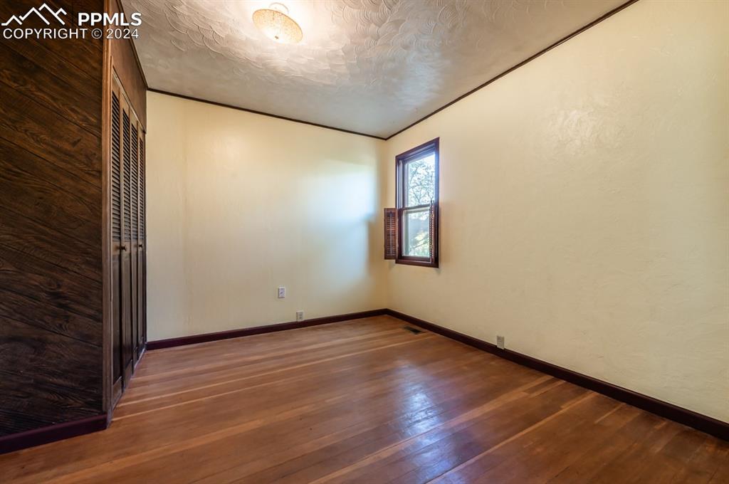 2233 Daniel Road Pueblo, CO 81006 - Photo 9 of 48 a view of an empty room with wooden floor and a window