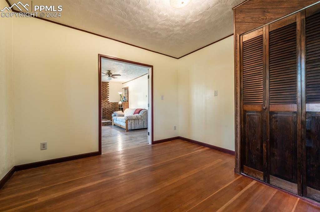 2233 Daniel Road Pueblo, CO 81006 - Photo 10 of 48 a view of a hallway view with wooden floor and bedroom view