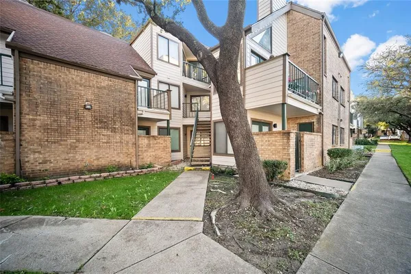 a view of a brick building next to a yard