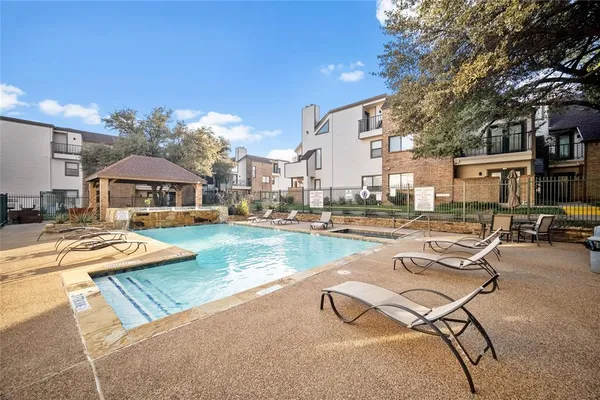 a view of a swimming pool with lounge chairs