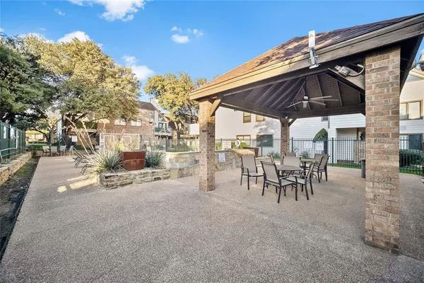 a view of outdoor space with table and chairs