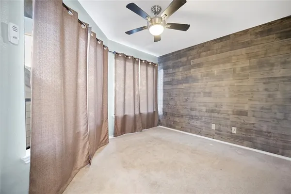 a view of a livingroom with a ceiling fan and shower