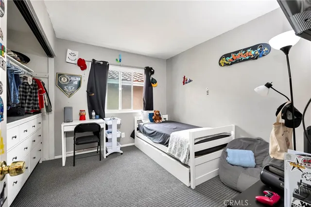 a bedroom with furniture and a window