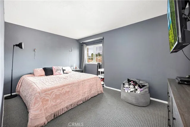 a bedroom with a bed and window