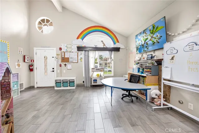 a view of a workspace with furniture and a window