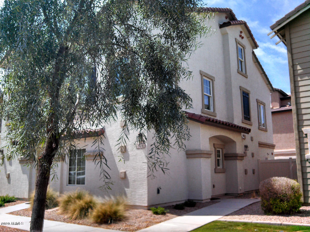 4081 East Windsor Drive Gilbert, AZ 85296 - Photo 1 of 8 a view of a house with a tree in front of it