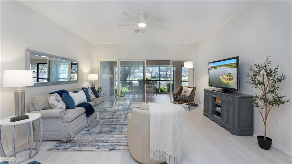 606 Arbor Lake Drive, Unit 6104 Naples, FL 34110 - Photo 1 of 36 a living room with furniture and a flat screen tv