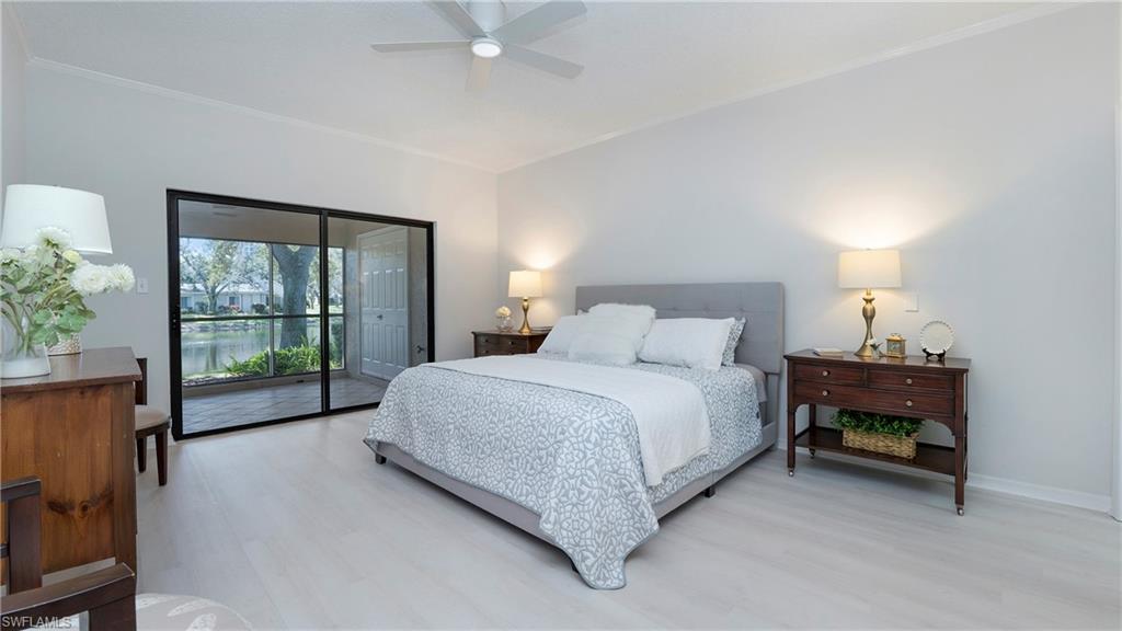 606 Arbor Lake Drive, Unit 6104 Naples, FL 34110 - Photo 11 of 36 a bedroom with a bed and a large window