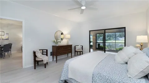 a bedroom with a bed a mirror and a table