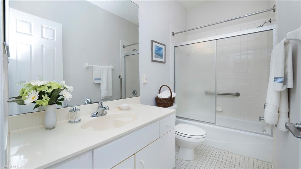 606 Arbor Lake Drive, Unit 6104 Naples, FL 34110 - Photo 20 of 36 a bathroom with a sink toilet and shower