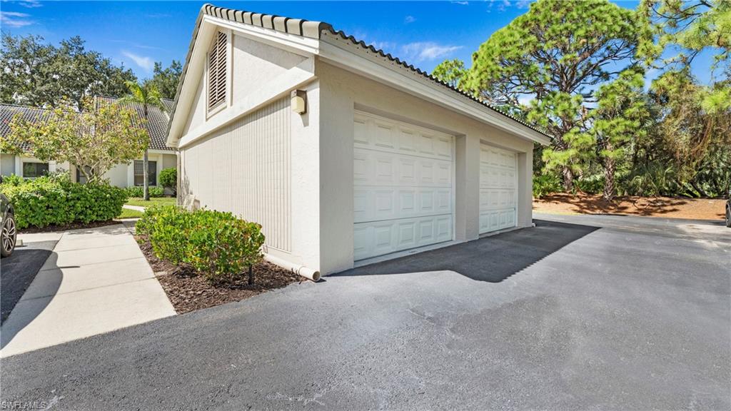 606 Arbor Lake Drive, Unit 6104 Naples, FL 34110 - Photo 21 of 36 a view of a house with a yard