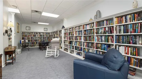 a living room with furniture and a book shelf