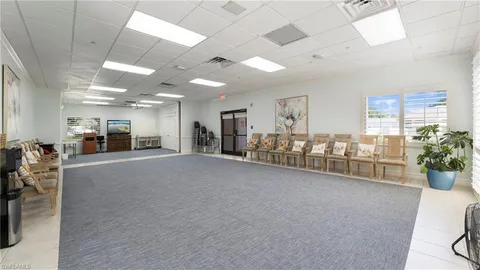 a room with furniture and potted plants