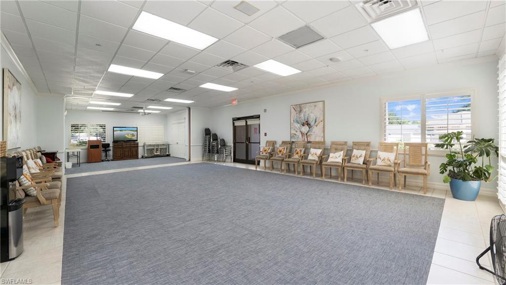 606 Arbor Lake Drive, Unit 6104 Naples, FL 34110 - Photo 31 of 36 a room with furniture and potted plants