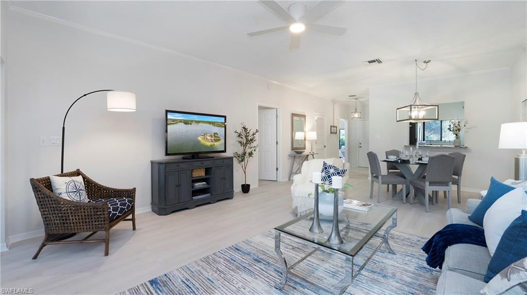606 Arbor Lake Drive, Unit 6104 Naples, FL 34110 - Photo 4 of 36 a living room with furniture and wooden floor