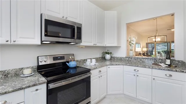 a kitchen with appliances a sink and cabinets